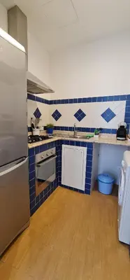 a kitchen with blue and white tiles on the wall at Di Fresco Apartments Luxury Suites in Palermo