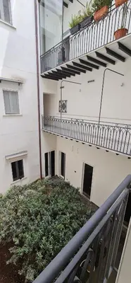 a balcony of a building with a staircase and plants at Di Fresco Apartments Luxury Suites in Palermo