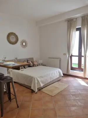 a bedroom with a bed and a table and a window at Giardino Moreno in Palermo