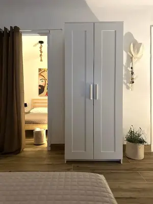 a bedroom with a white wardrobe and a bed at Il Moro in Carini