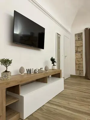 a living room with a tv on a wall at Il Moro in Carini