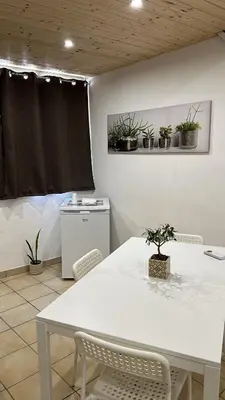 a white table and chairs in a kitchen with plants at Il Moro in Carini