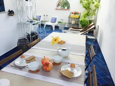 a table with plates and bowls of food on it at The k house in Palermo