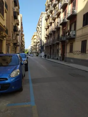 a blue car parked on the side of a street at casa nike in Palermo