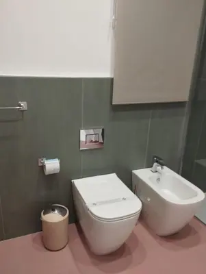 a bathroom with a white toilet and a sink at casa nike in Palermo