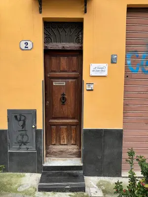 a wooden door on the side of a building at Al Parlatoio del Centro Storico in Palermo