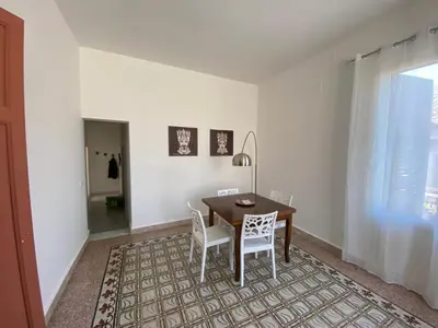 a dining room with a table and white chairs at Al Parlatoio del Centro Storico in Palermo