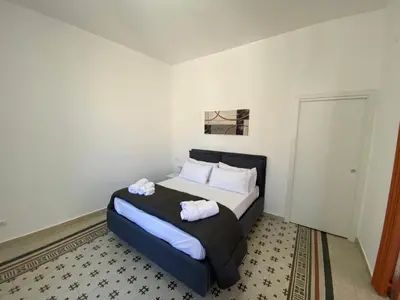 a bedroom with a bed with two towels on it at Al Parlatoio del Centro Storico in Palermo