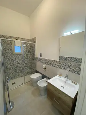 a bathroom with a sink and a toilet and a shower at Al Parlatoio del Centro Storico in Palermo