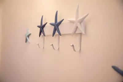 a group of five star hooks hanging on a wall at Beddamuri home in Carini