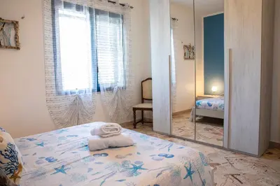 a bedroom with a bed with a mirror on it at Beddamuri home in Carini