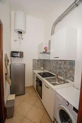 a kitchen with a sink and a dishwasher at La Dimora di David in Bagheria