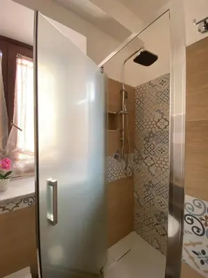 a shower with a glass door in a bathroom at La Dimora di David in Bagheria