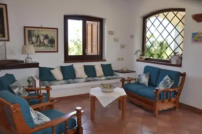 a living room with a couch and two chairs at Villa Cala Rossa Antonella in Castellammare del Golfo
