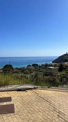 a view of the ocean from a balcony of a house at TorreNormanna Prestige House near Cefalù in Mandra Capreria