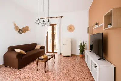 a living room with a couch and a tv at - Palermo - Sferracavallo sul mare in Palermo
