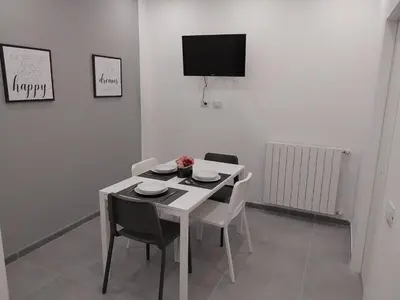a dining room with a white table and chairs at Amunì o 123 in Palermo