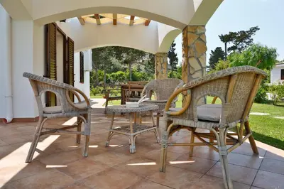 a group of chairs and a table on a patio at verdemare in relax in Cefalù