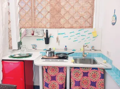 a small kitchen with a sink and a stove at Villa Mondello Terraces & Jacuzzi in Mondello