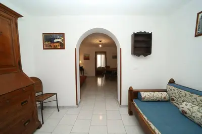 a bedroom with a bed and a couch at Colonna House Casa vacanze tra la Zisa e la Cattedrale in Palermo