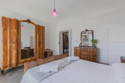 a bedroom with a large bed and a mirror at Ballarò Market Street Art Stylish Flat x10 in Palermo