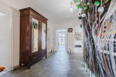 a hallway with a wooden cabinet in a room at Ballarò Market Street Art Stylish Flat x10 in Palermo