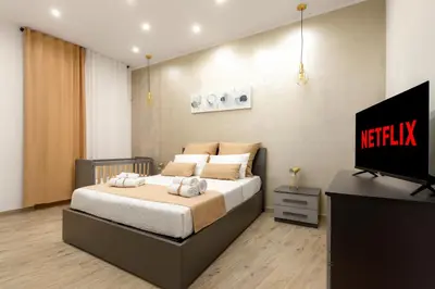a bedroom with a bed and a television in it at [The historical center of Palermo] La Dolce Vita in Palermo