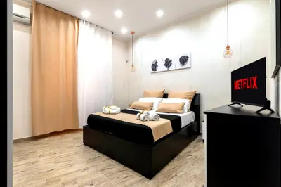 a bedroom with a bed and a television in it at [The historical center of Palermo] La Dolce Vita in Palermo