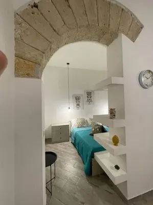 a bedroom with a bed and a table in a room at Sea sicily home in Santa Flavia
