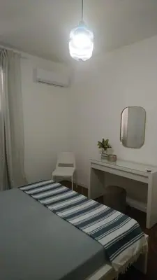 a bedroom with a bed and a table and a mirror at Loft 407 in Cinisi