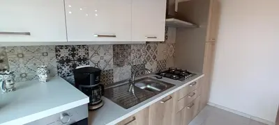 a small kitchen with a sink and a stove at Palazzo DS in Castellammare del Golfo