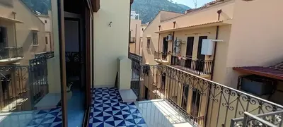 a balcony of a building with a blue and white tile floor at Palazzo DS in Castellammare del Golfo
