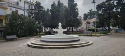 a large white fountain in the middle of a street at Piazza Vittoria Apartment in Carini