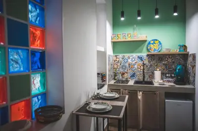 a kitchen with colorful tiles on the wall at ZA HOUSE in Palermo