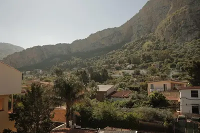 a view of a town with a mountain in the background at Sikelìa Bed & Breakfast in Carini