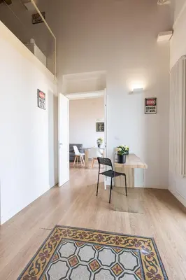 a room with a table and a chair and a rug at SHANTI HOLIDAY HOUSE in Palermo