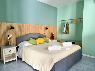a bedroom with a bed and a vase on the wall at Aurum by DomuSicily in Mondello