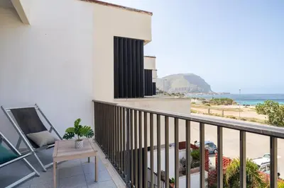a bedroom with a bed and a tv and a dresser at Aurum by DomuSicily in Mondello