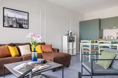 a kitchen and dining room with a table and chairs at Aurum by DomuSicily in Mondello