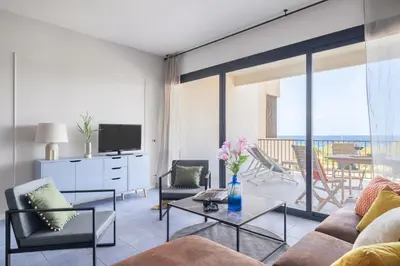 a living room with a couch and chairs and a television at Aurum by DomuSicily in Mondello