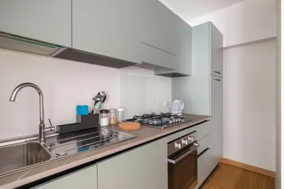a kitchen with a sink and a stove at Giusà by DomuSicily in Palermo