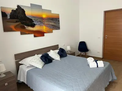 a bedroom with a bed with blue stuffed animals on it at Casa Corbezzolo in Balestrate