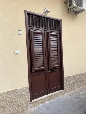 a wooden door on the side of a building at Casa Corbezzolo in Balestrate