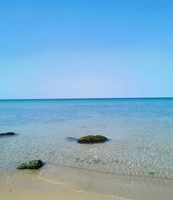 two rocks in the water on a beach at Casa Corbezzolo in Balestrate