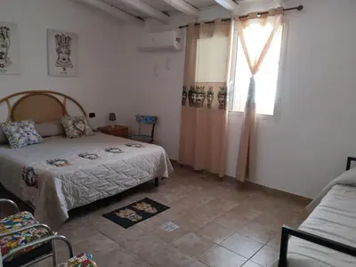 a bedroom with a bed and a window at B&B Sikelia in Terrasini