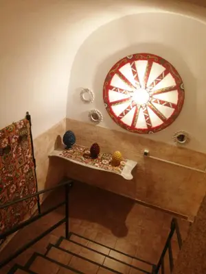 a room with a large wheel on the wall at B&B Sikelia in Terrasini