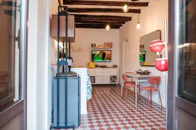 a kitchen with a table and chairs in a room at caZÁ ~ Palermo in Palermo