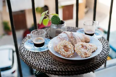 a table with a plate of donuts and two drinks at caZÁ ~ Palermo in Palermo