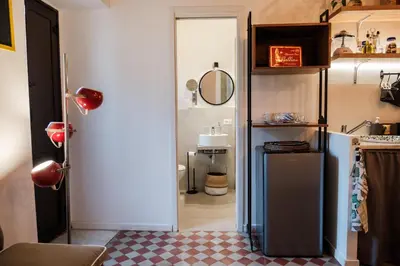 a kitchen with a refrigerator in a room at caZÁ ~ Palermo in Palermo