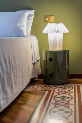 a bedroom with a bed and a lamp on the floor at Casa Bentivegna in Palermo